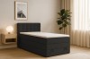 Gemütliches Schlafzimmer mit modernem schwarzen Boxspringbett, Nachttisch und Zimmerpflanze.