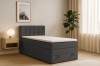 Stilvolles Schlafzimmer mit dem anthrazitfarbenen Boxspringbett JUNG I, Nachttisch und Dekoration.