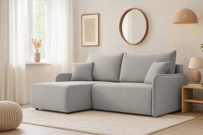 Hellgraues Ecksofa in L-Form in einem modern eingerichteten Wohnzimmer mit heller Dekoration.