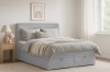 Modernes graues Boxspringbett mit Bettkasten in gemütlicher Schlafzimmer-Atmosphäre.