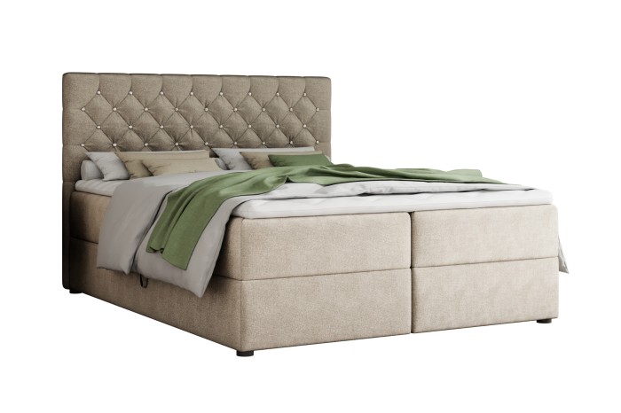 Elegant boxspring bed in beige with decorative button tufting on the high headboard.