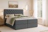 Modern slaapkamerambiance met een donkergrijs boxspringbed.