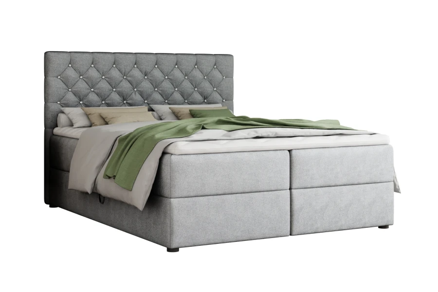 Graues Boxspringbett mit modernem Design und gestepptem Kopfteil.