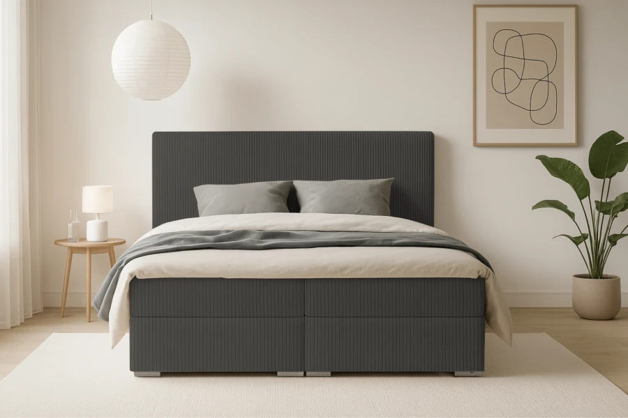 Stijlvol boxspringbed Lon IV in het grijs, vooraanzicht in een licht ingerichte kamer.