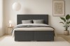 Modernes dunkelgraues Boxspringbett in Frontansicht mit minimalistischer Deko.