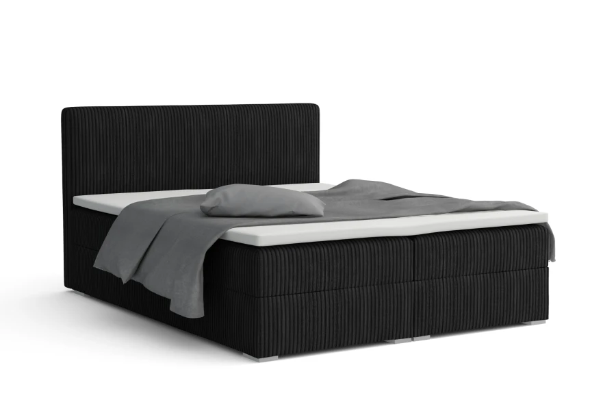 Schwarzes Boxspringbett mit strukturiertem Kopfteil, isoliert auf Weiß.