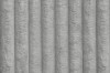 Nahaufnahme der grauen Cord-Textur eines Polsterbetts.
