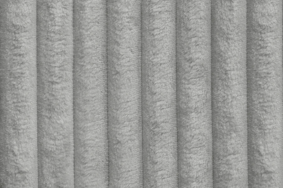 Nahaufnahme der grauen Cord-Textur eines Polsterbetts.