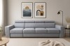 Gemütliches Sofa ELMO im Wohnzimmer-Ambiente mit moderner Wanddeko und Teppich.
