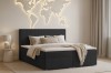 Schlafzimmer-Ambiente mit schwarzem Boxspringbett und beleuchteter Weltkarte.