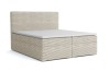 Modernes Boxspringbett in Beige mit Cord-Bezug und hohem Kopfteil für komfortablen Schlaf.