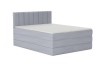 Hellgraues Boxspringbett mit Bettkasten und vertikal gestepptem Kopfteil.