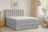 Stilvolles hellgraues Boxspringbett in einem gemütlich eingerichteten Schlafzimmer.