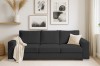 Elegantes anthrazitfarbenes Cord-Sofa in einem hell eingerichteten Wohnzimmer.