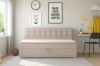 Beiges Kindersofa mit Knopfheftung am Kopfteil in einem hellen Kinderzimmer mit Schreibtisch.