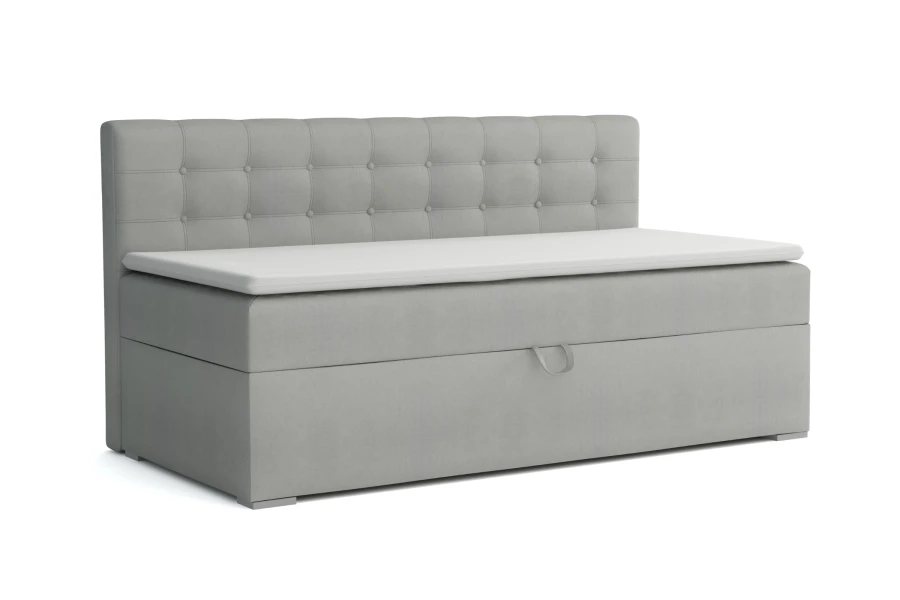 Light grey upholstered bench with storage box and decorative button tufting on the headboard.