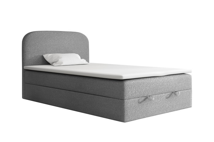 Grey boxspring single bed with white topper and headboard on a white background.