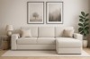 Eingerichtetes Wohnzimmer mit cremefarbenem Bouclé-Sofa, Wandbildern und Zimmerpflanze.