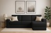 Stilvolles schwarzes Ecksofa im modern eingerichteten Wohnzimmer mit Deko.