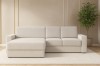 Modernes cremefarbenes Ecksofa im Wohnzimmer-Ambiente mit Pflanze