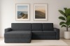 Dunkelgraues Ecksofa im Wohnzimmer-Ambiente mit Bildern und Pflanze.