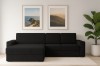Schwarzes Ecksofa in einem modern eingerichteten Wohnzimmer mit Wandbildern und Zimmerpflanze.