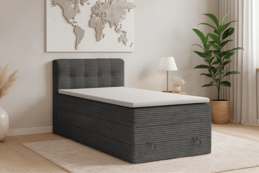 Graues Boxspringbett Jung II mit Cord-Bezug und weißem Topper in modernem Schlafzimmer.