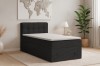 Modernes schwarzes Boxspringbett im Cord-Design in einem hellen Schlafzimmer.