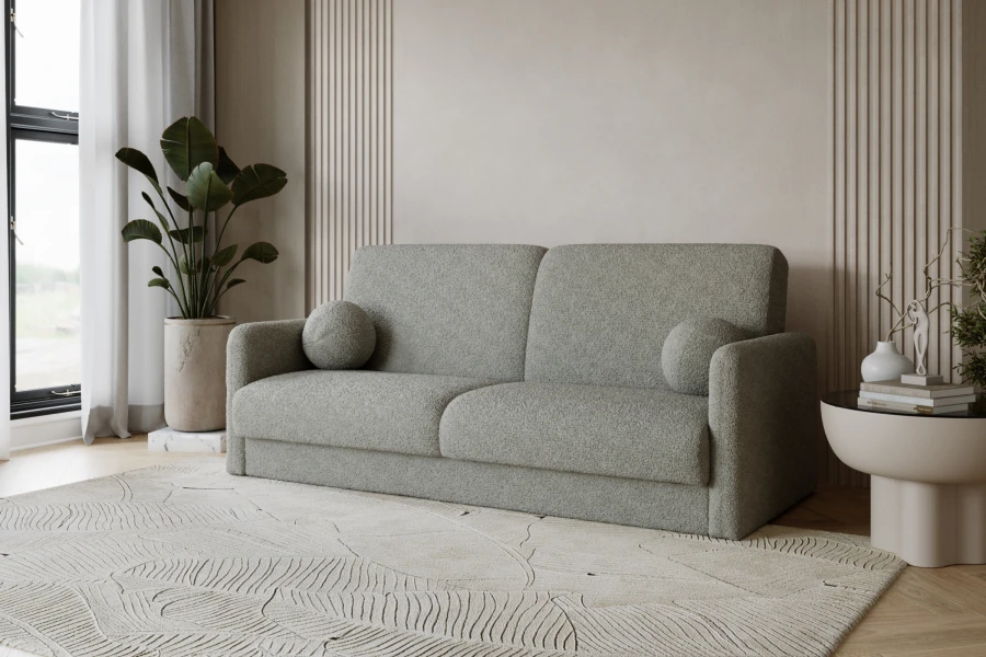 Modernes graues Bouclé-Sofa in einem hellen, minimalistischen Wohnzimmer mit Pflanzen.