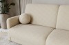 Detailansicht eines beigen Bouclé-Sofas mit rundem Dekokissen und weicher Textur.