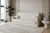 Elegantes beiges Sofa aus Bouclé-Stoff in modernem Wohnambiente mit Teppich.