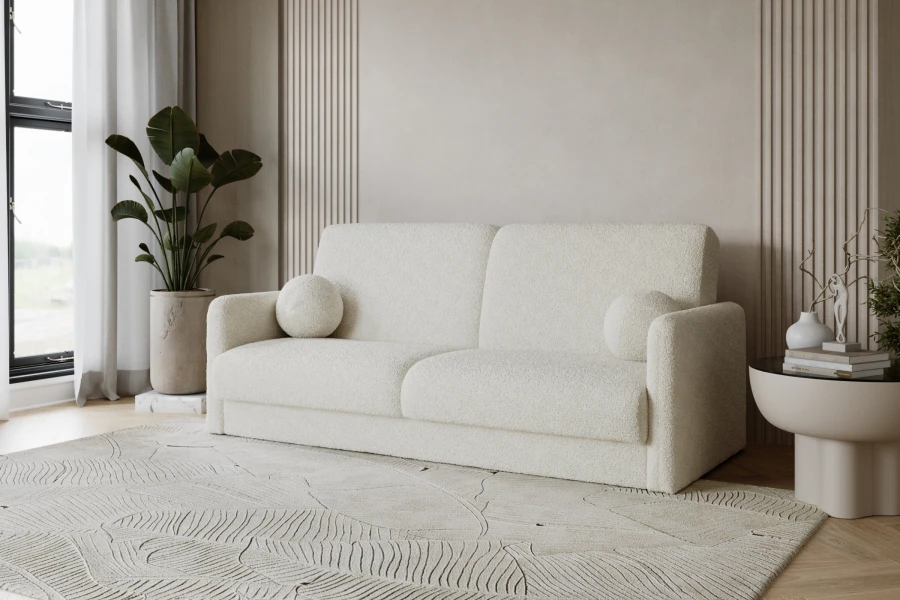 Elegantes beiges Sofa aus Bouclé-Stoff in modernem Wohnambiente mit Teppich.