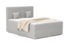 Modernes graues Boxspringbett mit stilvollem Cordbezug, passenden Kissen und gemütlicher Tagesdecke.
