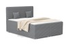Graues Boxspringbett in moderner Cord-Optik mit passenden Kissen und Decke.