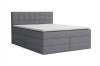 Graues Boxspringbett mit gestepptem Kopfteil und weißem Topper, isoliert auf weißem Hintergrund.