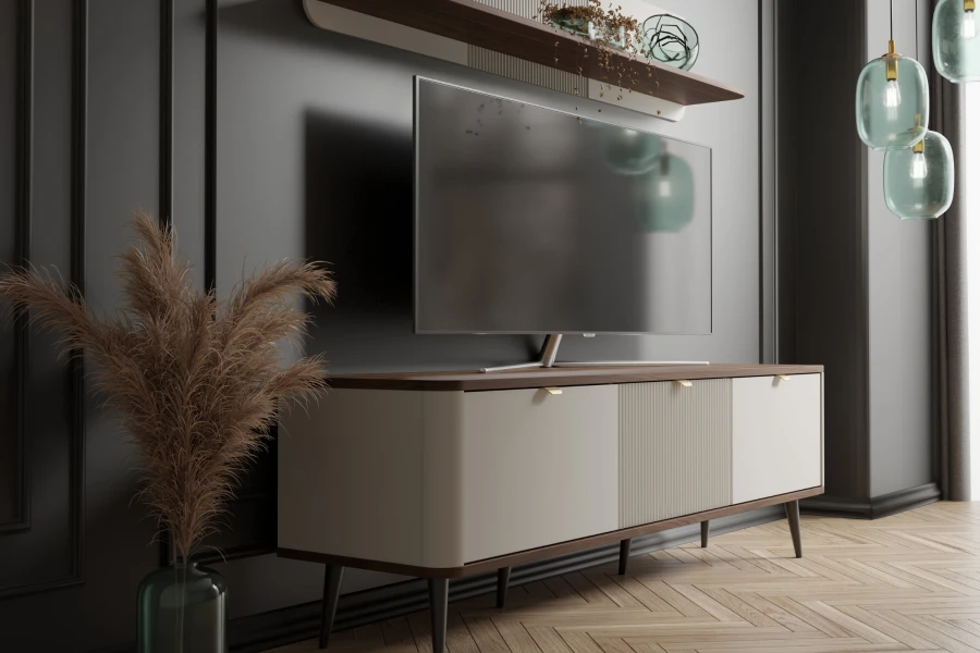 Modernes TV-Lowboard mit cremefarbener Front vor dunkler Wand, dekoriert mit Trockenblumen.