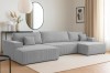 Gemütliches graues Ecksofa aus Cord in einem modern eingerichteten Wohnzimmer.