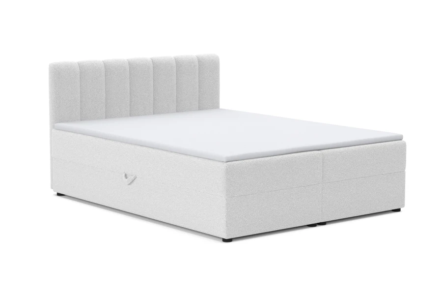 Weißes Boxspringbett mit gepolstertem Kopfteil in moderner Optik für Schlafzimmer.