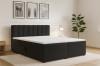 Stilvolles Schlafzimmer mit schwarzem Polsterbett und moderner Dekoration.