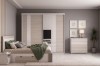 Modernes Schlafzimmer-Set in Beige mit Schiebetürenschrank, Bett mit Stauraum und passender Kommode.