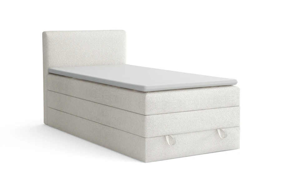 Modernes weißes Boxspringbett aus Bouclé-Stoff mit Kopfteil auf weißem Hintergrund.