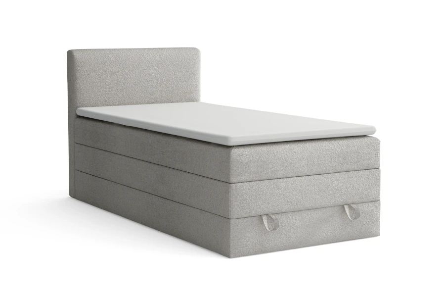 Hellgraues Boxspring-Einzelbett mit strukturiertem Bouclé-Bezug und integriertem Topper.