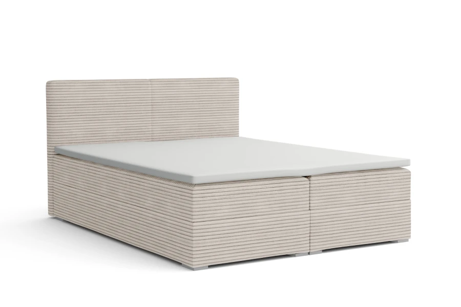 Doppel-Boxspringbett in hellem Cord-Bezug freigestellt.
