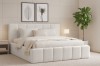 Stilvolles Schlafzimmer-Ambiente mit hellem Designerbett und Wandbildern.