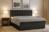 Dunkelgraues Boxspringbett Claudia mit hohem Kopfteil und Stauraum, ideal für modernen Schlafkomfort.