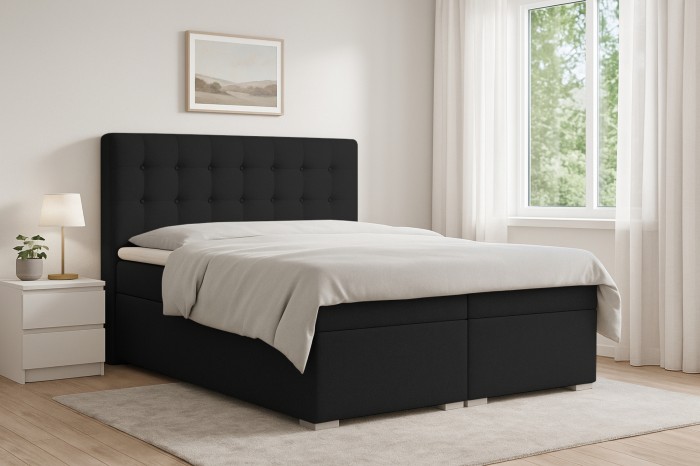 Modernes schwarzes Boxspringbett Claudia in einem hellen Schlafzimmer mit Fenster und Nachttisch.
