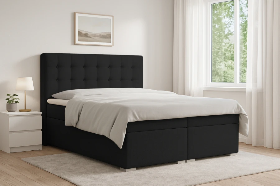 Modernes schwarzes Boxspringbett Claudia in einem hellen Schlafzimmer mit Fenster und Nachttisch.