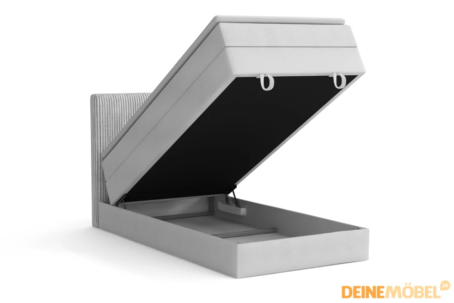 Hellgraues Boxspringbett mit geöffnetem Bettkasten für praktischen Stauraum.