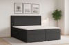 Elegantes anthrazitfarbenes Boxspringbett mit hohem Kopfteil und weißem Topper für modernen Schlafkomfort.