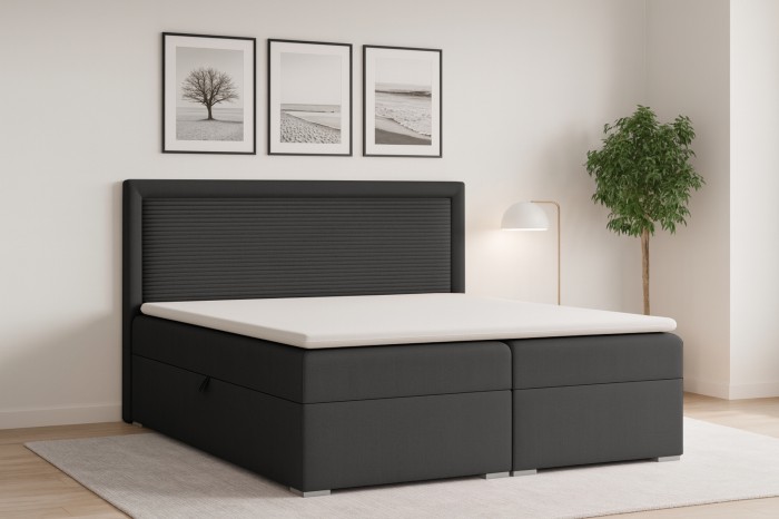 Anthrazitfarbenes Boxspringbett mit geriffeltem Kopfteil und weißem Topper im modernen Schlafzimmer.